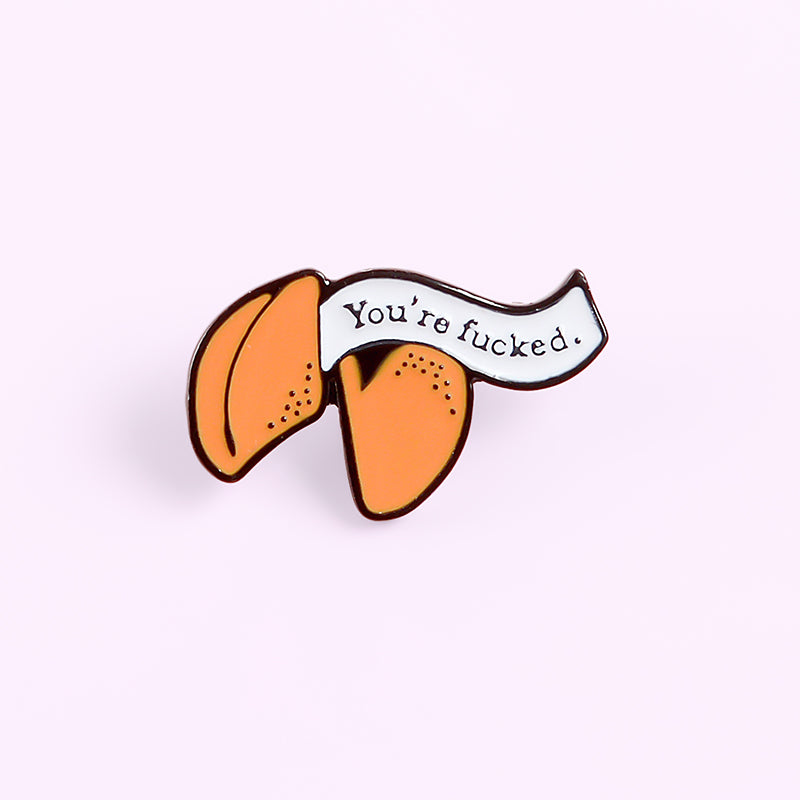 Enamel pin with cartoon fortune cookie dripping oil — back view