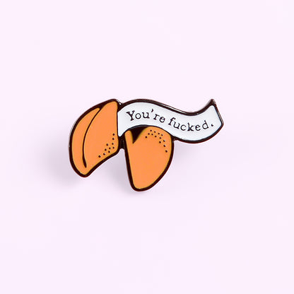 Enamel pin with cartoon fortune cookie dripping oil — back view