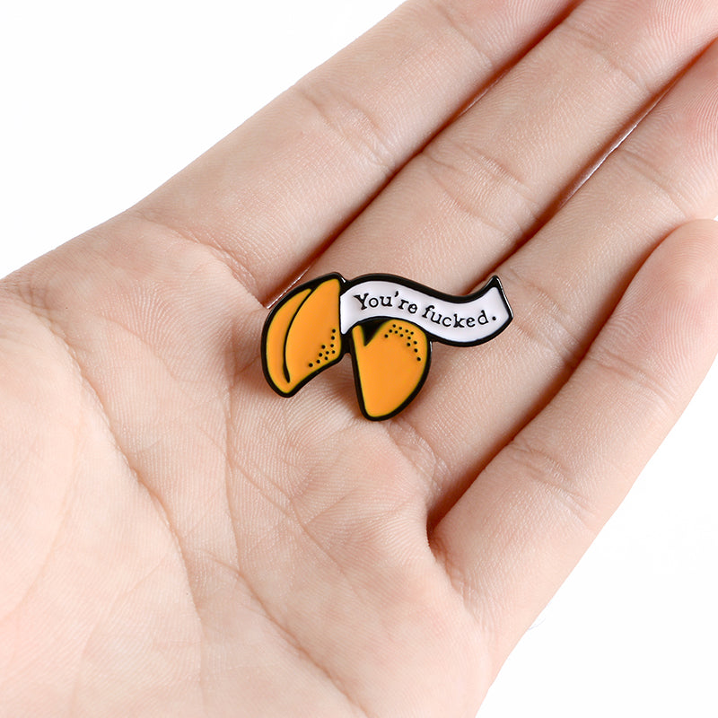 Enamel pin with cartoon fortune cookie dripping oil — packaging