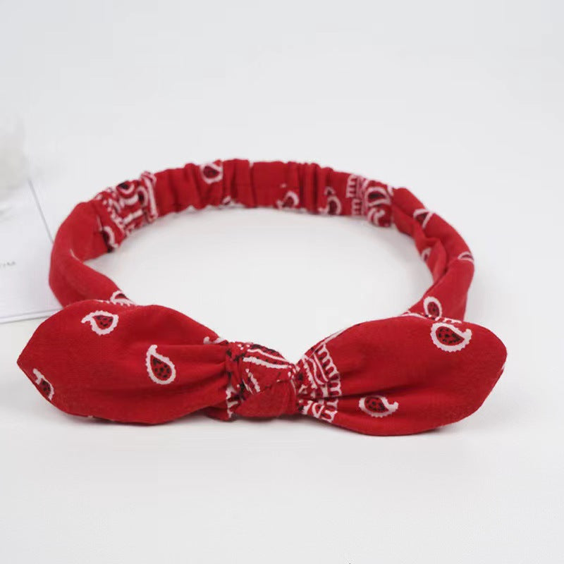 Bunny ears knotted elastic headband — in use
