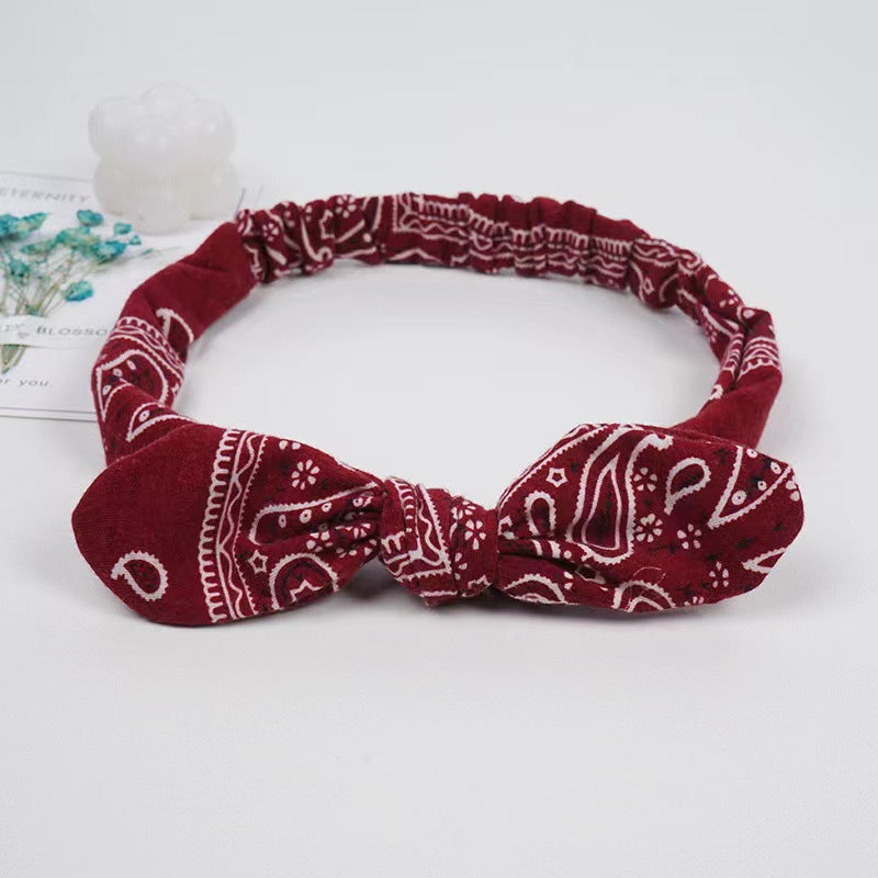 Bunny ears knotted elastic headband — back view